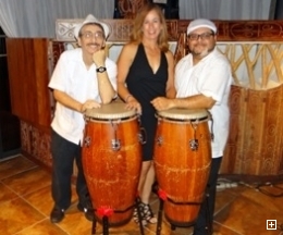 Photo of the 3-piece Caliente Tropical band with conga drums